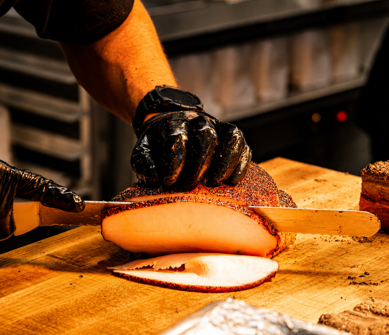 Pitmaster slicing smoked turkey breast on a butcher block